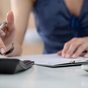 woman filling out forms and doing calculations