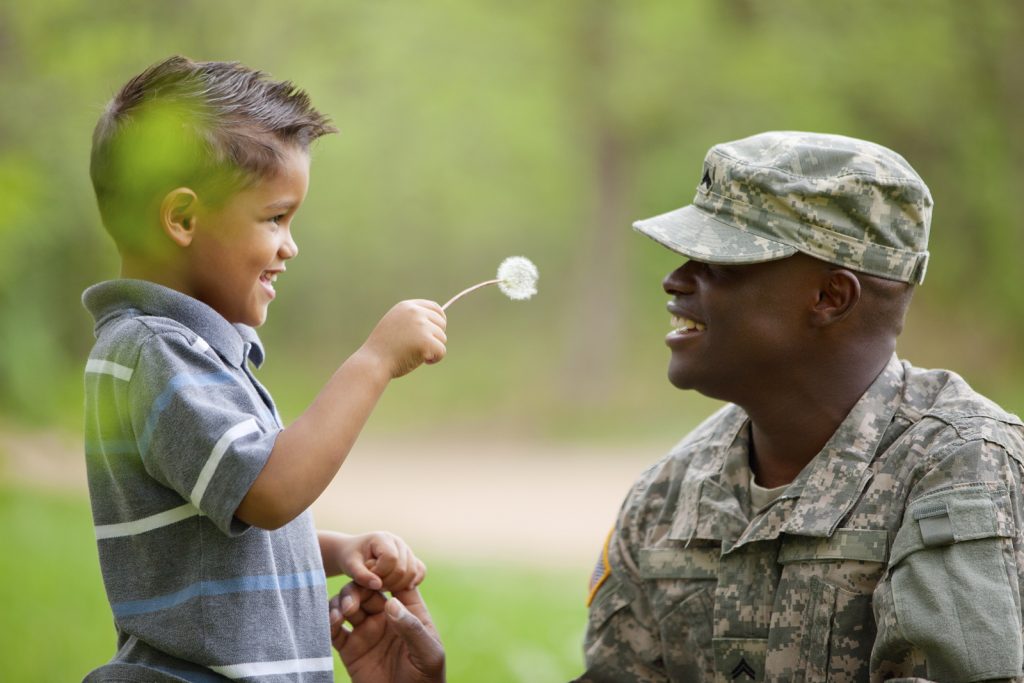 child looking at solider