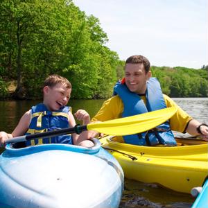 Father and son kayaking in nature