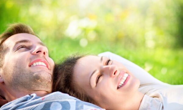 Smiling couple lying in the grass